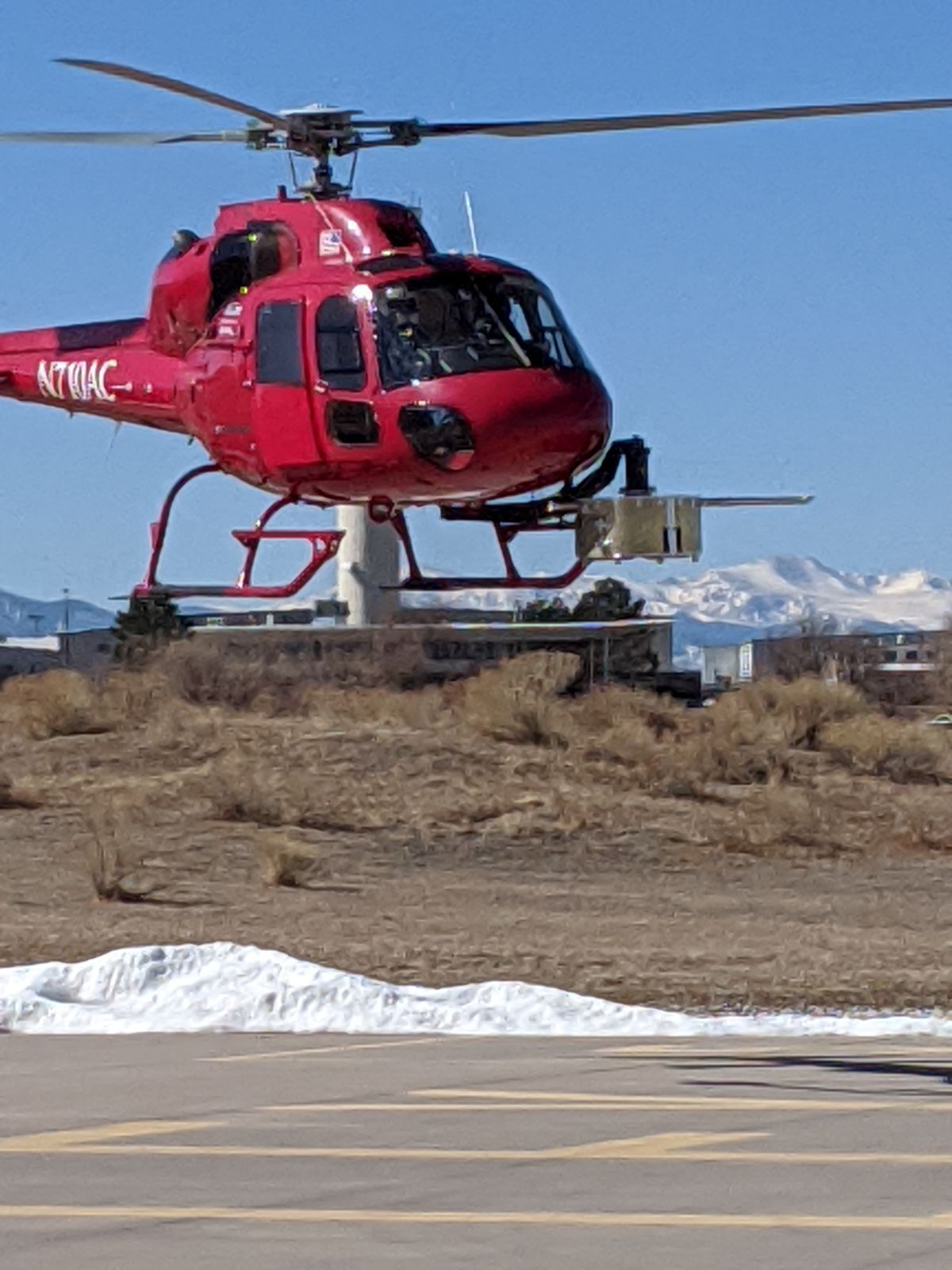 AirCam TwinStar helicopter with the snow-covered Rockies behind