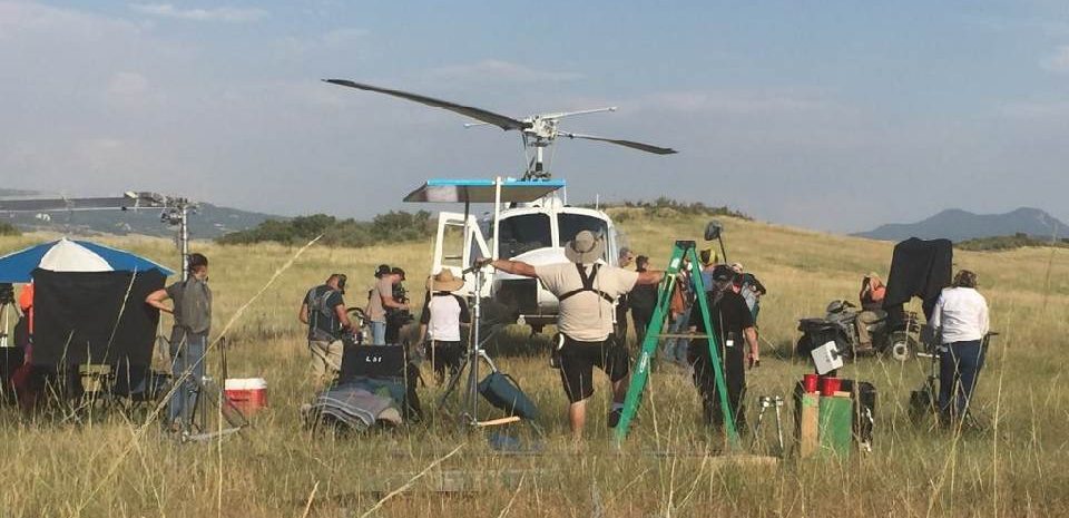 Film crew working around the helicopter on location