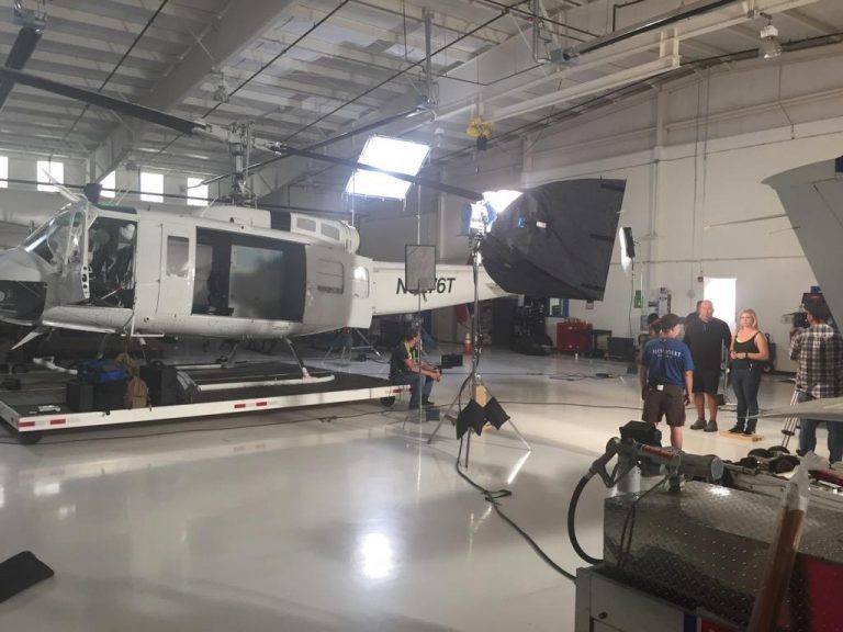Bell 205 in the hangar with crew